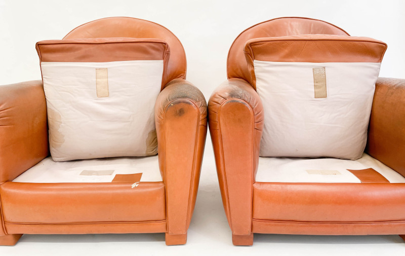 Leather club chairs and ottoman in the style of Ralph Lauren