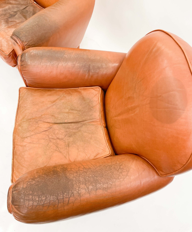 Leather club chairs and ottoman in the style of Ralph Lauren