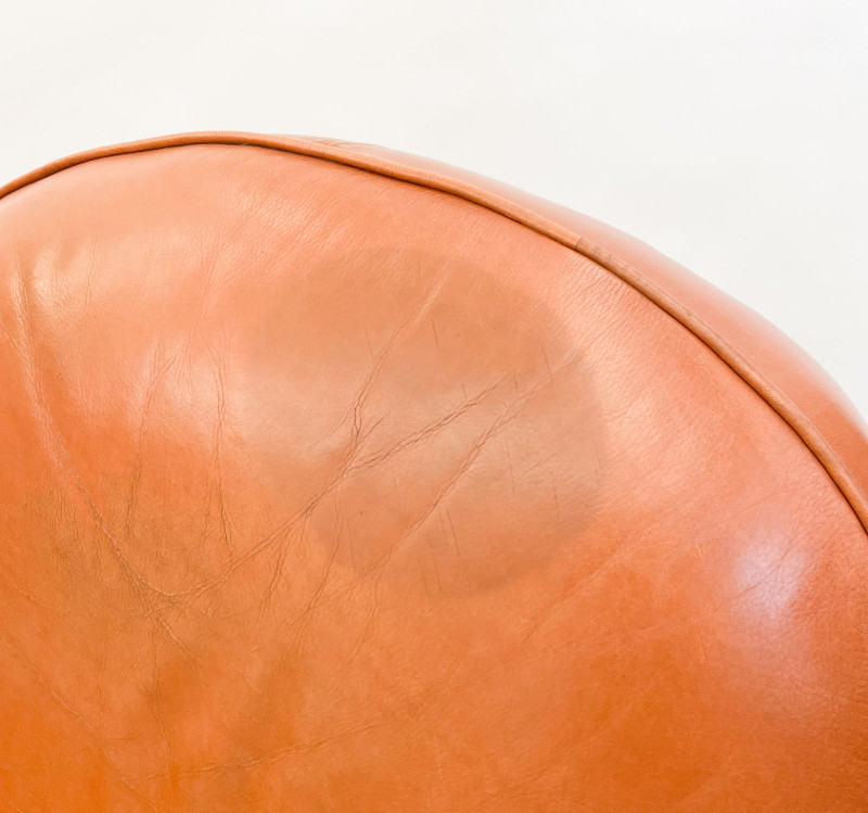 Leather club chairs and ottoman in the style of Ralph Lauren