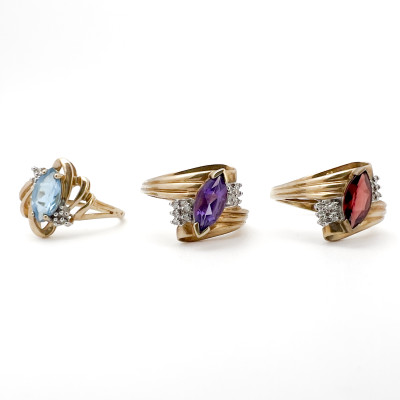 Three Yellow Gold Rings with Gems Topaz Garnet Amethyst