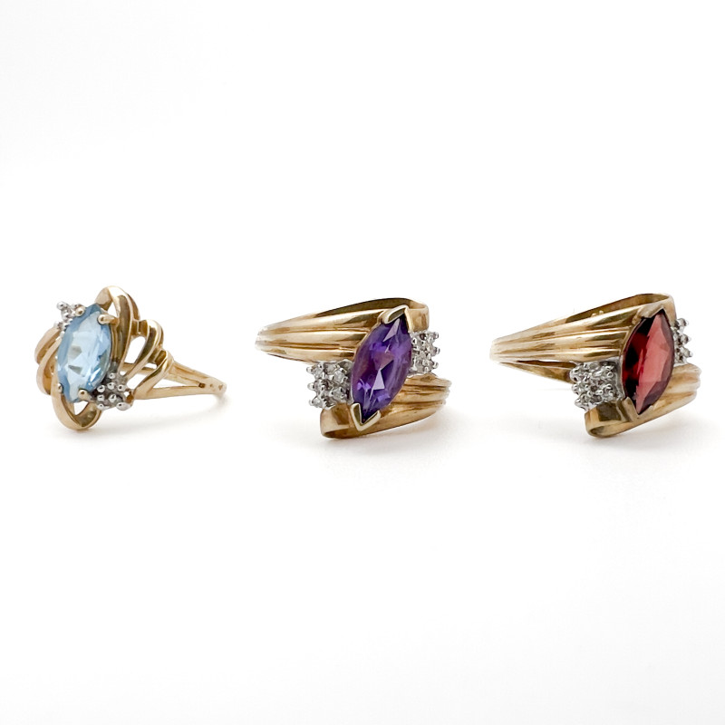 Three Yellow Gold Rings with Gems Topaz Garnet Amethyst
