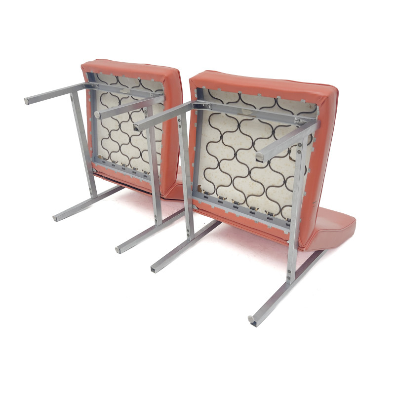 A Pair of Mid-Century Modern Orange Vinyl Slipper Chairs