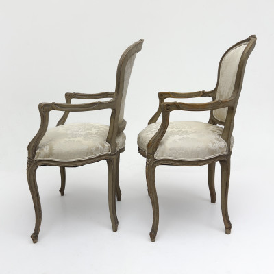 A Pair of Louis XV Style Carved Beechwood Fauteuils