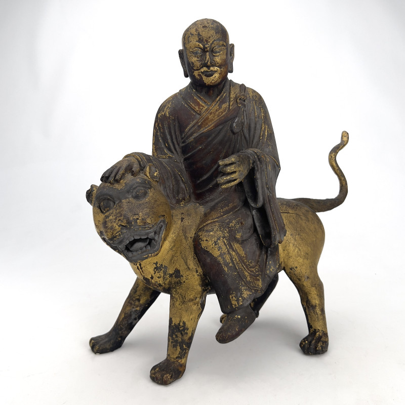 Chinese Polychrome and Parcel-Gilded Wood Figure of a Buddhist Arhat Riding a Lion