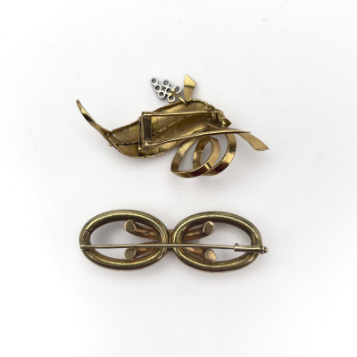 A two-piece 14k gold and platinum brooch lot containing diamonds