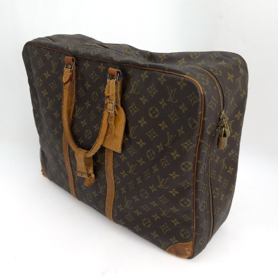 Louis Vuitton - A four-piece leather travel lot
