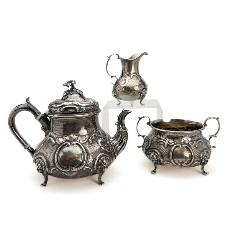A Victorian British Sterling Silver Repoussé Three-Piece Tea Service