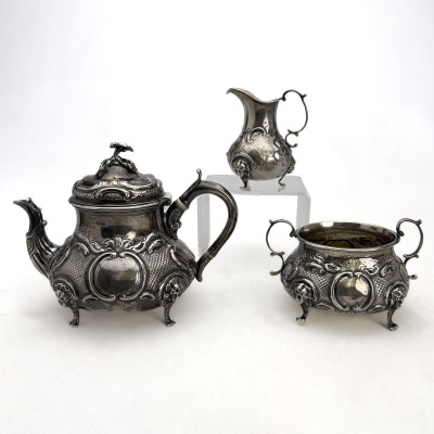 A Victorian British Sterling Silver Repoussé Three-Piece Tea Service