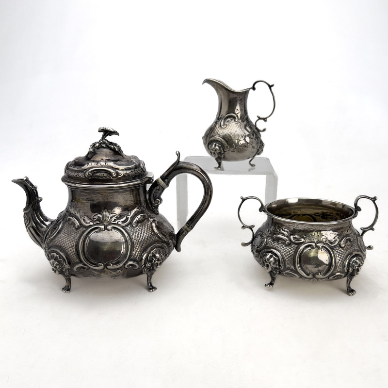 A Victorian British Sterling Silver Repoussé Three-Piece Tea Service