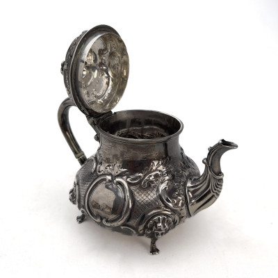 A Victorian British Sterling Silver Repoussé Three-Piece Tea Service