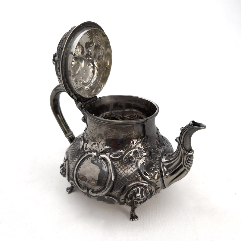 A Victorian British Sterling Silver Repoussé Three-Piece Tea Service